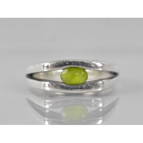 217 - A Heavy Modernist Peridot and Silver Ring with Oval Cut Stone Measuring 5.6mm by 3.3mm, Tension Set ... 