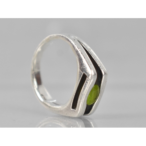 217 - A Heavy Modernist Peridot and Silver Ring with Oval Cut Stone Measuring 5.6mm by 3.3mm, Tension Set ... 