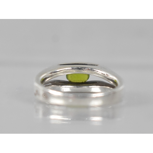 217 - A Heavy Modernist Peridot and Silver Ring with Oval Cut Stone Measuring 5.6mm by 3.3mm, Tension Set ... 