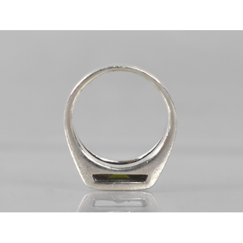 217 - A Heavy Modernist Peridot and Silver Ring with Oval Cut Stone Measuring 5.6mm by 3.3mm, Tension Set ... 