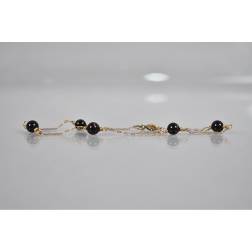 103 - A Late 19th/Early 20th Century Black Coral and Gold Coloured Metal Bracelet, Five Black Coral Beads ... 