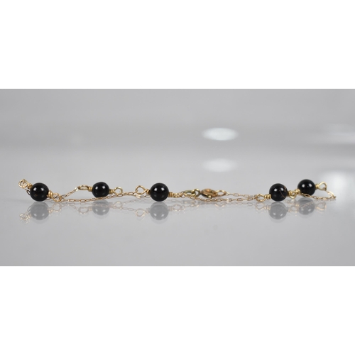 103 - A Late 19th/Early 20th Century Black Coral and Gold Coloured Metal Bracelet, Five Black Coral Beads ... 