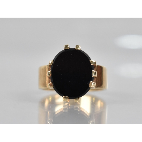 123 - A Onyx and 9ct Gold Signet Ring, Oval Onyx Panel Measuring 14mm by 12.2mm Diameter Raised in Ten Wid... 