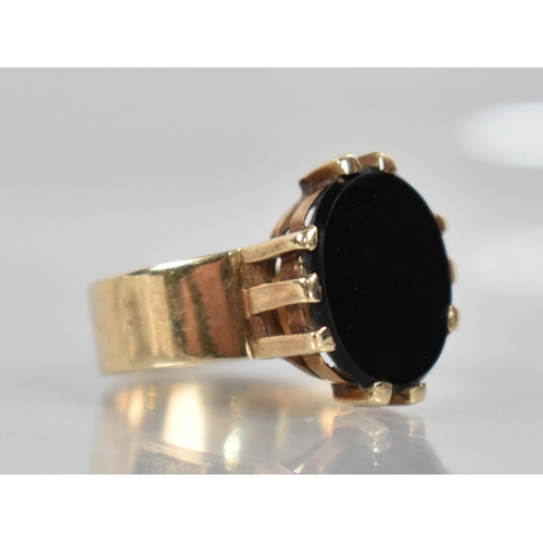 123 - A Onyx and 9ct Gold Signet Ring, Oval Onyx Panel Measuring 14mm by 12.2mm Diameter Raised in Ten Wid... 