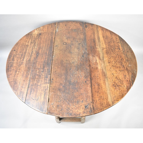 131 - A 19th Century Oak Gate Leg Drop Leaf Dining Table with Oval Top, 124cms Wide