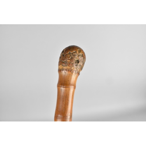 133 - An Oriental Carved Bamboo Walking Cane, 95cms Long