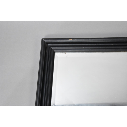 269 - A Large Ebonized Framed Rectangular Wall Mirror, 134cms by 104cms