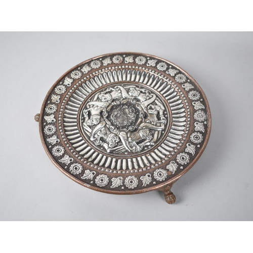 67 - An Indian Silver Copper Circular Plate on Three Claw Feet, Decorated with Leaves and Flowers, Centre... 