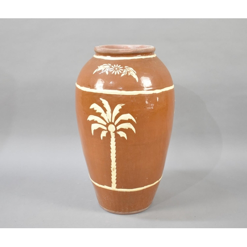 82 - A Large Terracotta Glazed Jar Decorated with Palm Trees, 64cms High