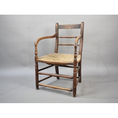 498 - An Early 20th Century Rush Seated Oak Framed Chair