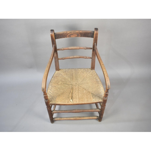 498 - An Early 20th Century Rush Seated Oak Framed Chair