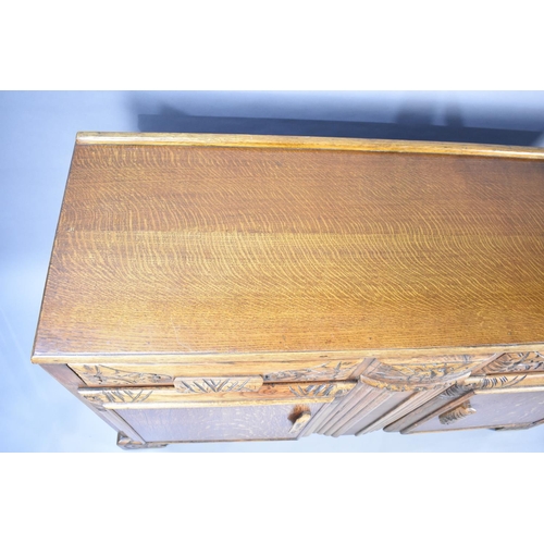 511 - A Mid 20th Century Oak Sideboard with Base Cupboards Surmounted by Two Short Drawers, 134x45x87cms