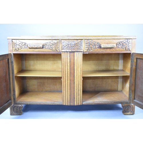 511 - A Mid 20th Century Oak Sideboard with Base Cupboards Surmounted by Two Short Drawers, 134x45x87cms