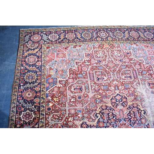 531 - An Early 20th Century Handmade Persian Heriz Pattern Carpet on Red Ground, C.1910, 390x298cm