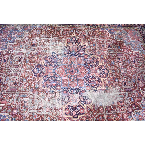 531 - An Early 20th Century Handmade Persian Heriz Pattern Carpet on Red Ground, C.1910, 390x298cm