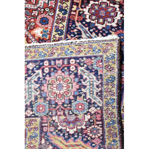 531 - An Early 20th Century Handmade Persian Heriz Pattern Carpet on Red Ground, C.1910, 390x298cm