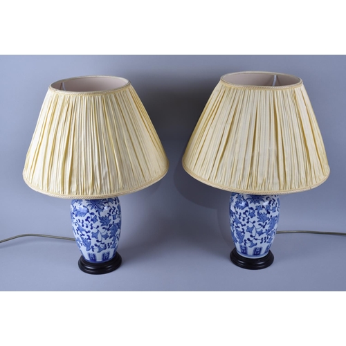 102 - A Pair of Oriental Blue and White Ceramic Vase Shaped Table Lamps, with Shades, 49cms High