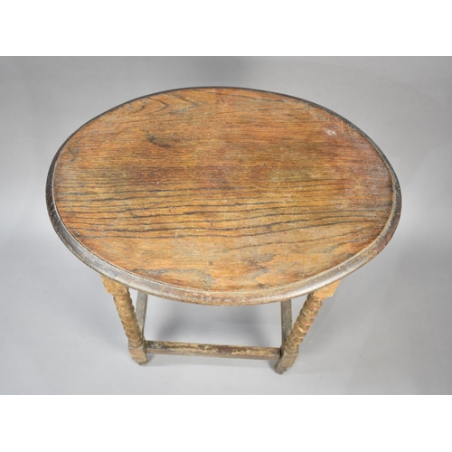 146 - An Edwardian Oak Oval Topped Occasional Table with Barley Twist Supports, 57cms Long