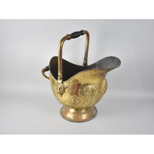 68 - A Mid 20th Century Brass Helmet Shaped Coal Scuttle with Relief Decoration and Turned Wooden Handle,... 