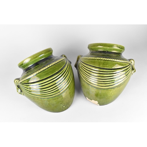 78 - A Pair of Green Glazed Stoneware Planters in the Form of Buried Amphora Vases, 26cms Wide