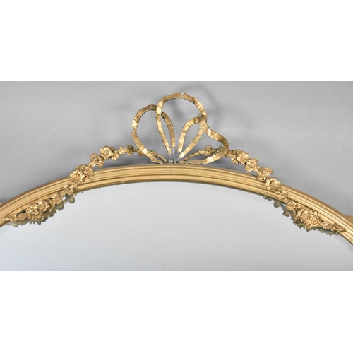 84 - An Edwardian Oval Wall Hanging Gilt Framed Mirror with Floral Swag and Ribbon Decoration, Condition ... 