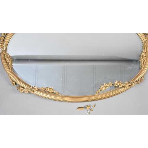 84 - An Edwardian Oval Wall Hanging Gilt Framed Mirror with Floral Swag and Ribbon Decoration, Condition ... 