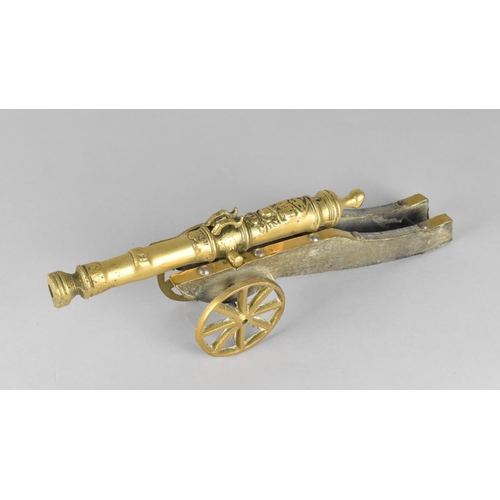 37 - A Mid 20th Century Brass and Wooden Model of a Continental Cannon, 35cms Long