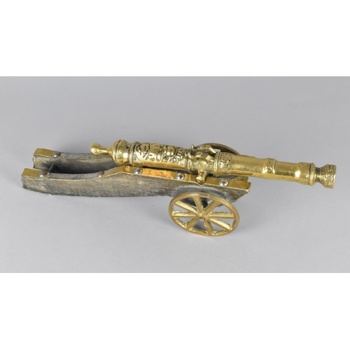 37 - A Mid 20th Century Brass and Wooden Model of a Continental Cannon, 35cms Long