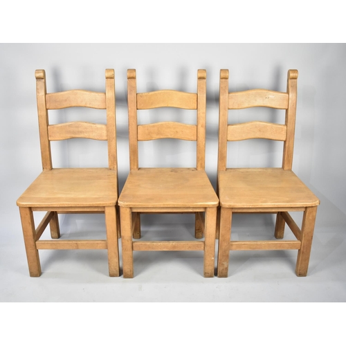 589 - A Set of Three Hardwood Ladder Back Dining Chairs