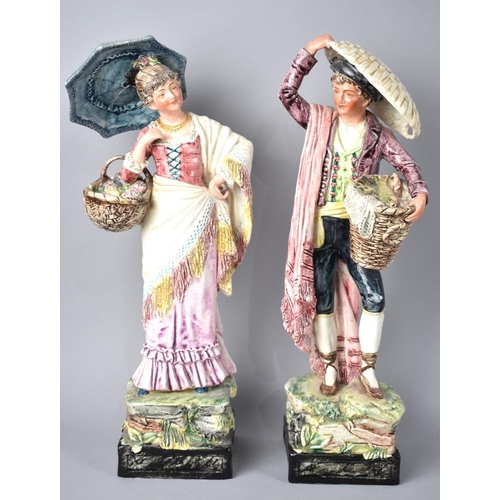 602 - A Pair of Continental Glazed Figural Ornaments, Gent with Basket of Fish and Lady with Basket of Flo... 