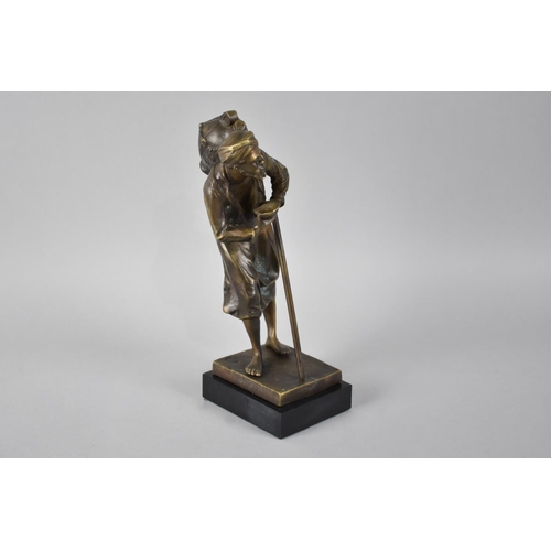 73 - A Reproduction Bronze Study of Arabic Water Carrier with Stick and Cup, In the Manner of Bergmann, 2... 