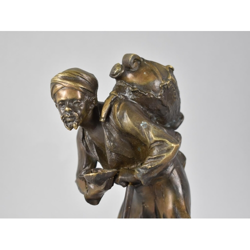 73 - A Reproduction Bronze Study of Arabic Water Carrier with Stick and Cup, In the Manner of Bergmann, 2... 