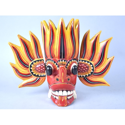 103 - A Sri Lankan Raksha Souvenir Carved and Painted Wooden Wall Hanging Mask, 23cms High