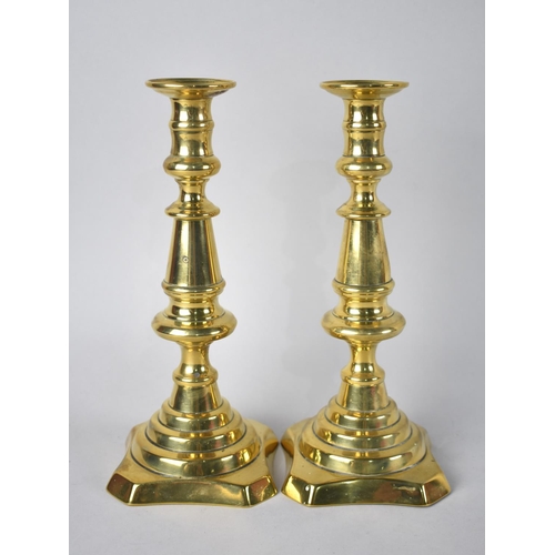 166 - A Pair of Victorian Brass Candlesticks with Pushers, 24.5cms High