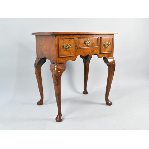 38 - A Reproduction Burr Walnut Lowboy with Small Centre Drawer Flanked by Two Deeper Drawers, Cabriole S... 