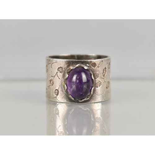 467 - A Silver Ring having Oval Cabochon Amethyst Stone on a Wide Textured Band, Stamped Internally MJR, S... 