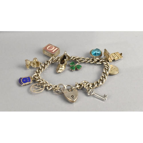 469 - A Silver Curb Link Charm Bracelet having Multiple Silver Charms top include Enamelled Shamrock, Type... 