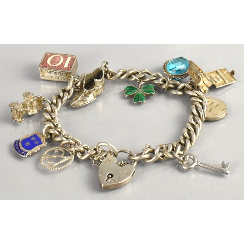 469 - A Silver Curb Link Charm Bracelet having Multiple Silver Charms top include Enamelled Shamrock, Type... 