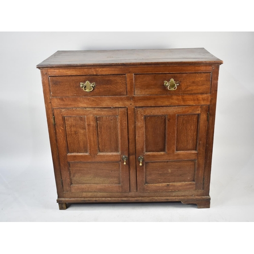 537 - An Edwardian Oak Side Cabinet with two Top Doors and Panelled Doors to Shelved Base, 110cms Wide