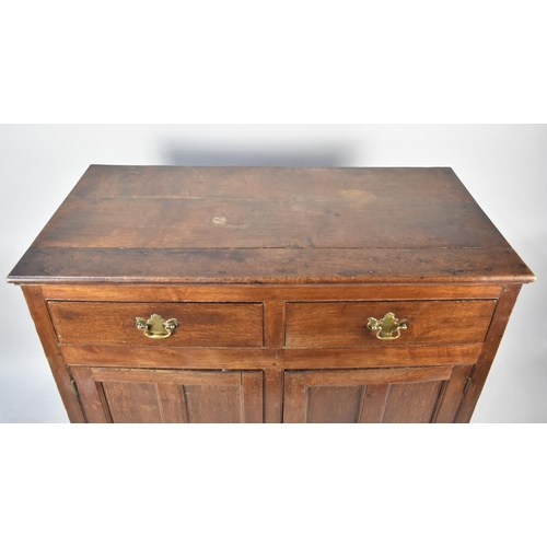 537 - An Edwardian Oak Side Cabinet with two Top Doors and Panelled Doors to Shelved Base, 110cms Wide