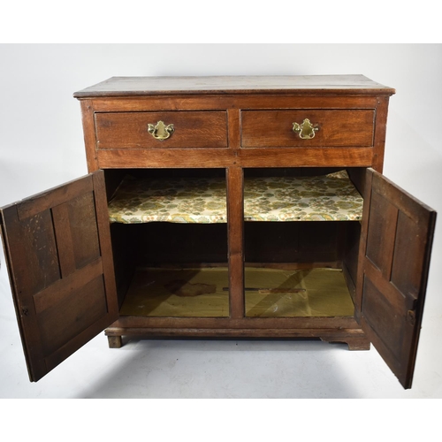 537 - An Edwardian Oak Side Cabinet with two Top Doors and Panelled Doors to Shelved Base, 110cms Wide