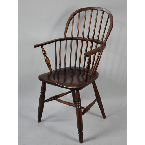 559 - A Reproduction Windsor Style Hooped Back Armchair