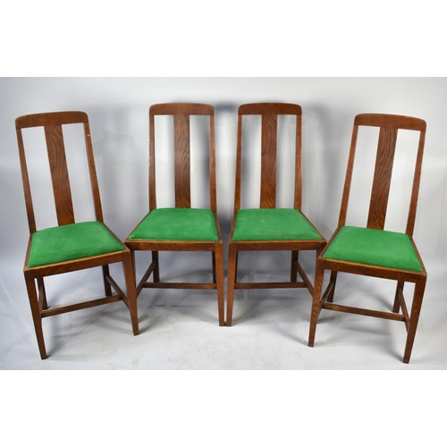 560 - A Set of Four Edwardian Oak Dining Chairs