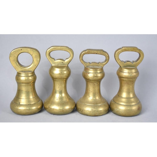 63 - A Collection of Four unrelated Brass Bell Weights, 2lbs, 20cms High