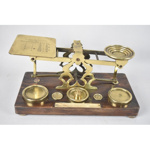 66 - A Late 19th/Early 20th Century Brass Postage Scales with Weights on Rectangular Wooden Plinth, 26.5c... 