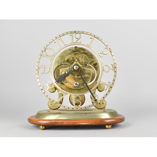 68 - A Mid 20th century Brass Skeleton Clock on Oval Wooden Plinth, Pendulum Feather Requires Replacing, ... 