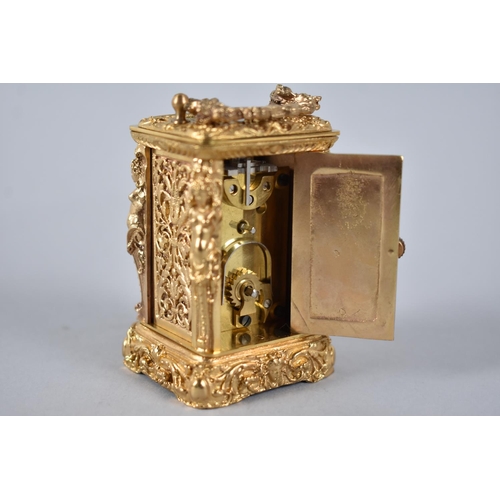 28 - A Reproduction Ornate Gilt Brass Miniature Carriage Clock with White Enamelled Dial, Complete with k... 