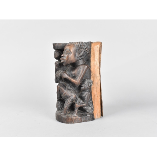 185 - A Carved Section of African Tree Trunk Depicting Family, 17cm high