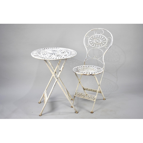 550 - A White Painted Oval Metal Garden Table and Matching Folding Chair