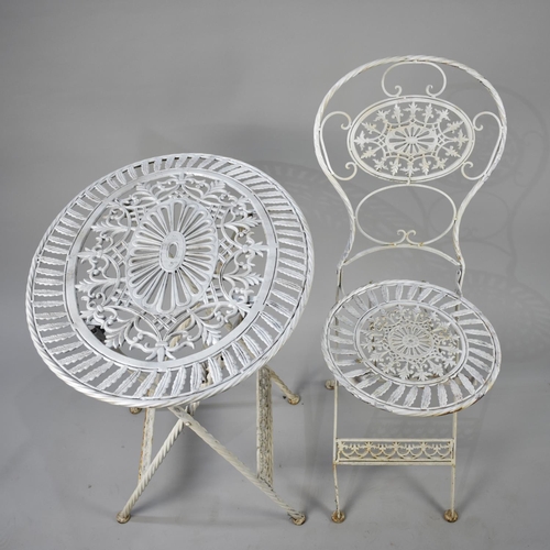 550 - A White Painted Oval Metal Garden Table and Matching Folding Chair